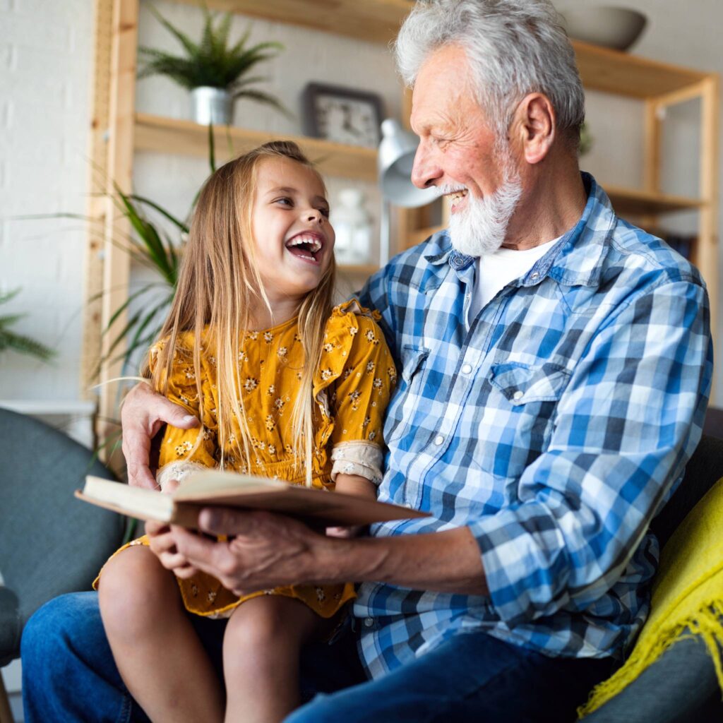 A grandfather reads to his young grandchild