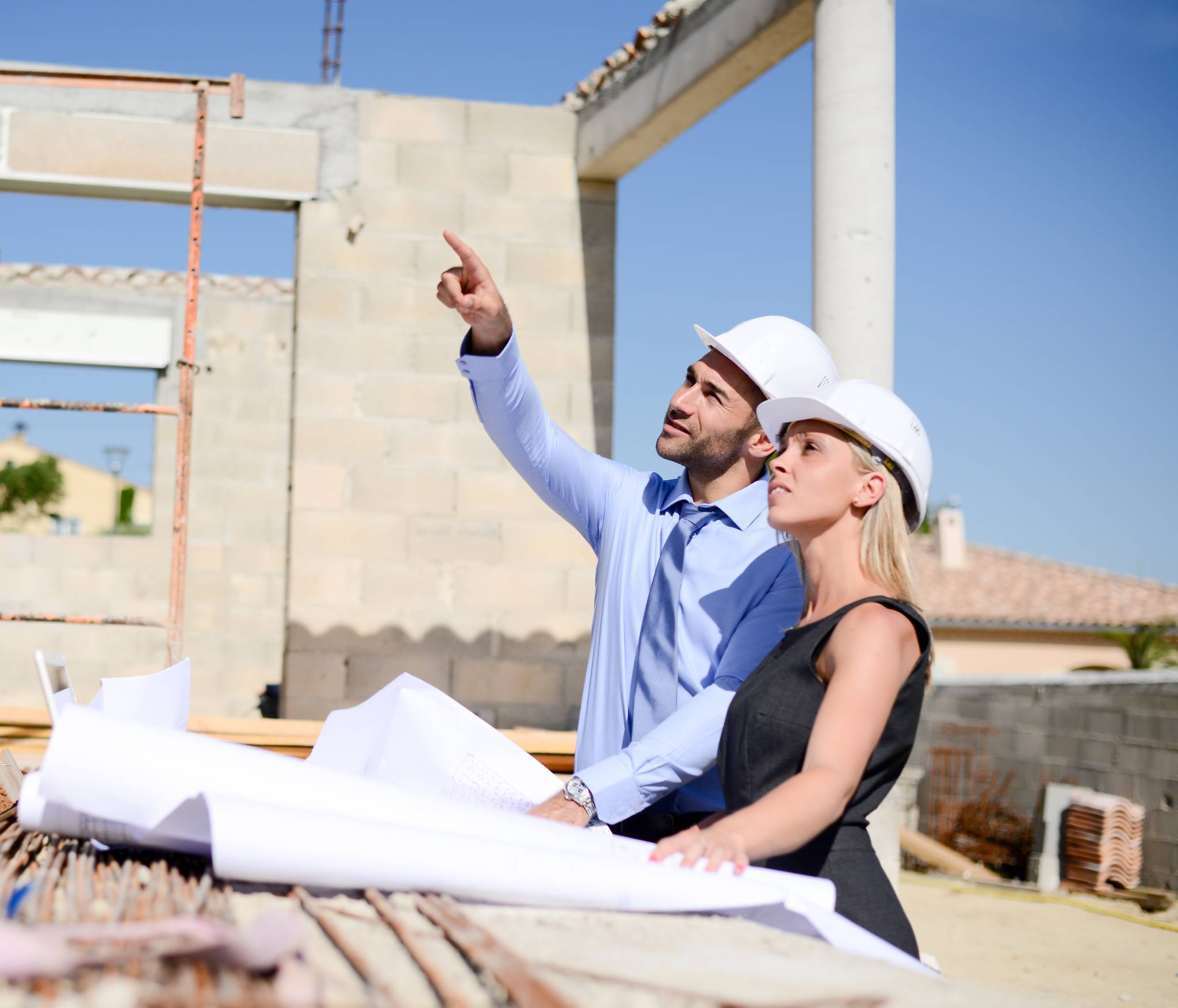 A man and a woman work at a construction site