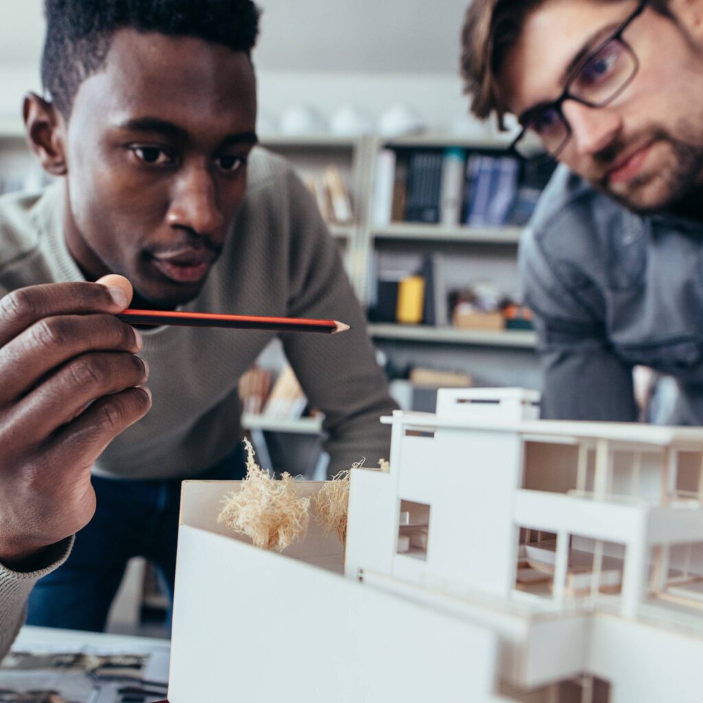 two men look at model home